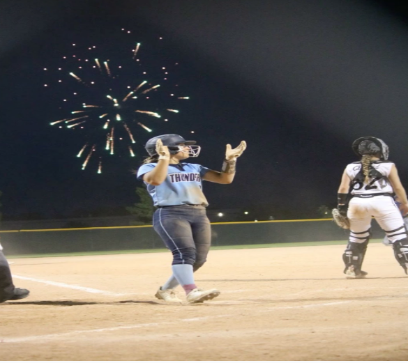 This image shows a softball player celebrating after hitting a home run as the fireworks set off in perfect timing. (photo from Pinterest)