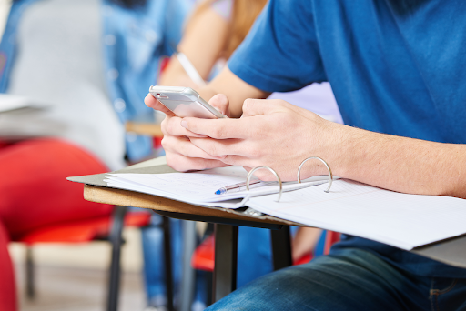 A picture of students constantly using their cell phones during class 
