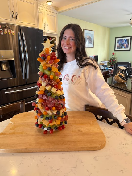 Ms. Popino next to a fruit tree ( photo courtesy of Ms. Popino)