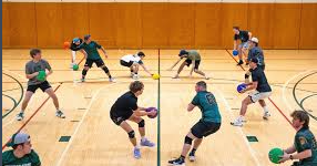 A dodgeball game (photo from https://statenews.com/article/2025/02/3-2-1-dodgeball-msu-wins-fourth-straight-michigan-cup-extends-dominance?ct=content_open&cv=cbox_latest)