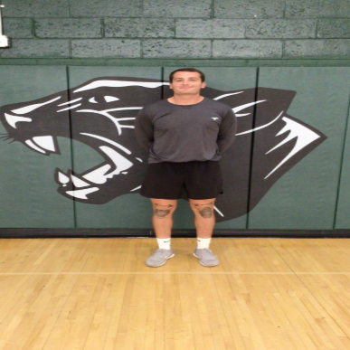 Photograph of Mr. Drucquer in the gymnasium.