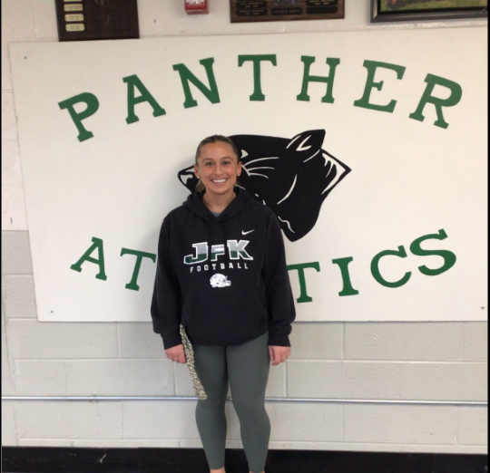 Mrs. Malleck standing in front of the Panther Athletics sign.